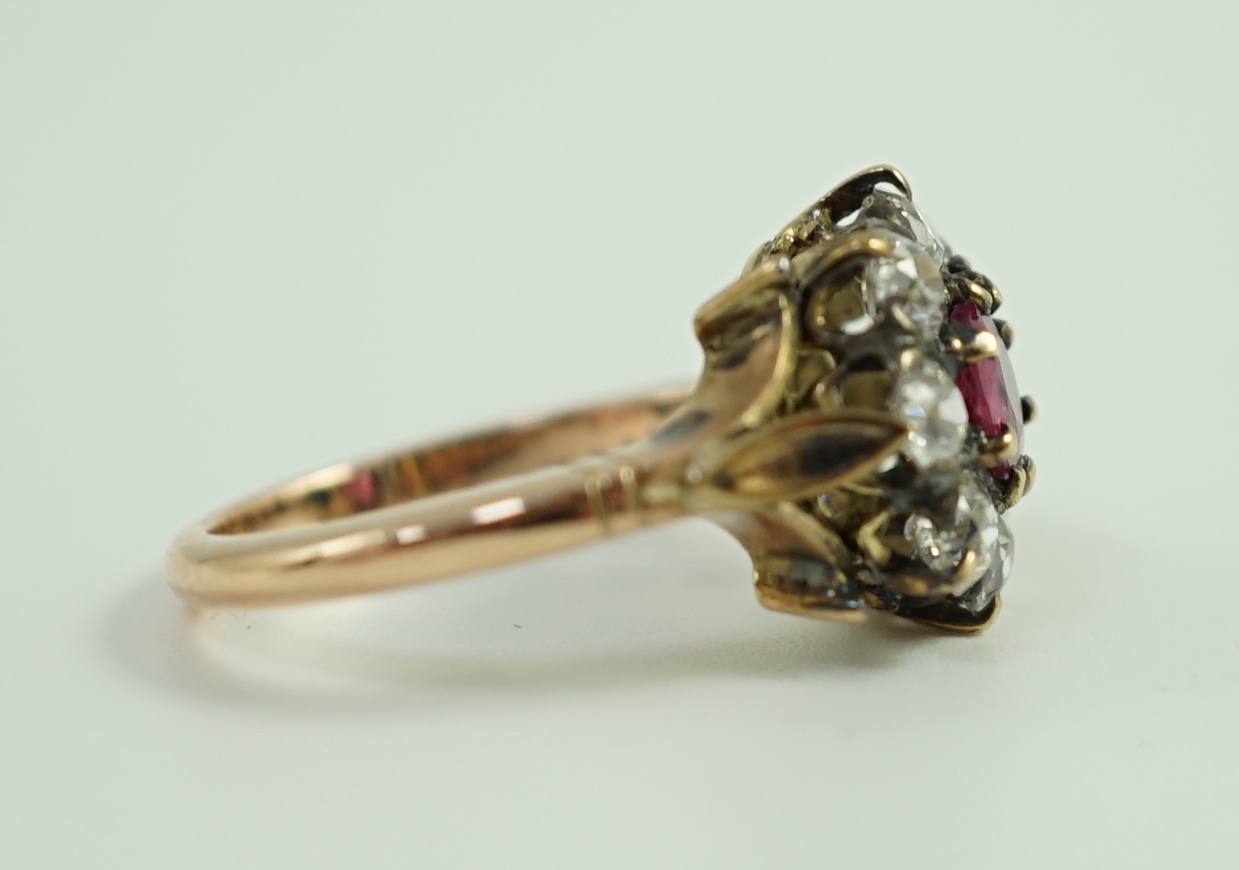 An antique gold, ruby and old cut diamond set circular cluster ring